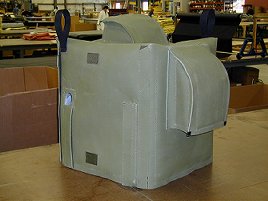 Noise reducing pump cover featuring ventilation baffles and flaps.